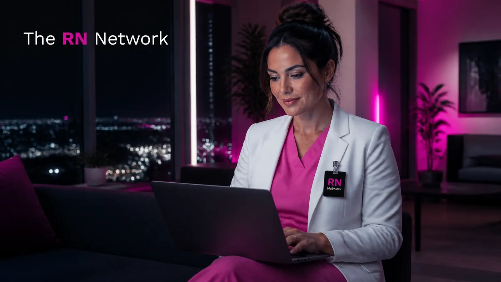 Nurse leader working on a laptop overlooking the city at night