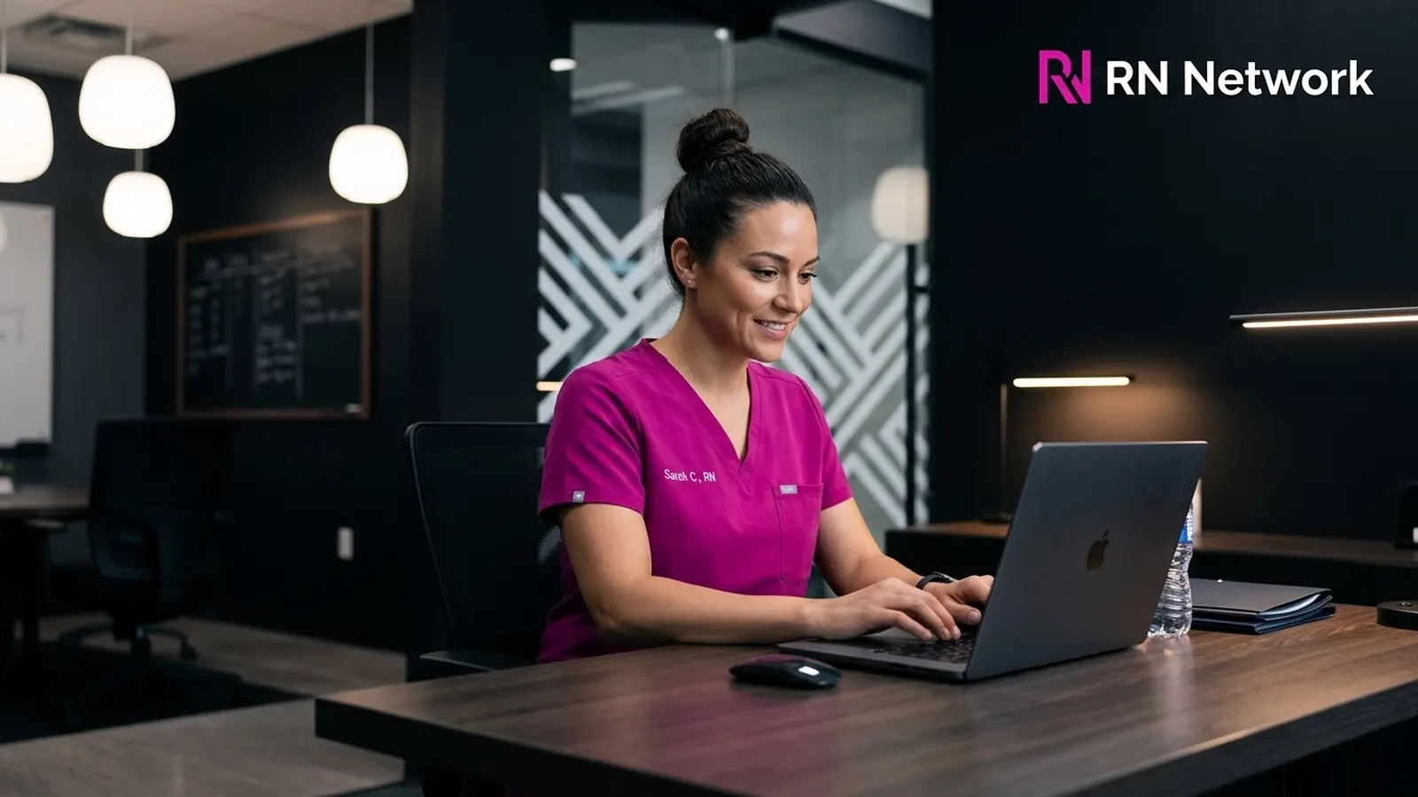 Nurse working on a laptop in a lounge
